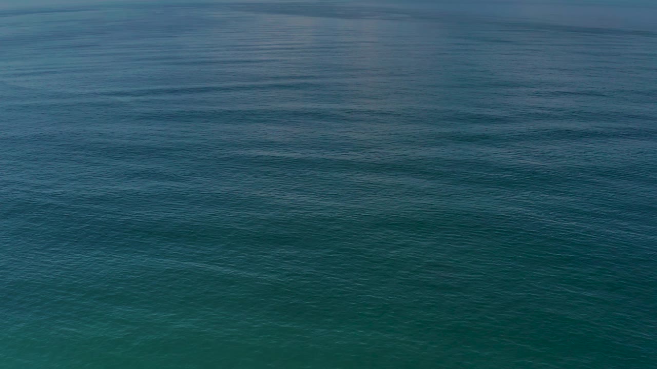 Blue-green sea surface in Los Cabos, Mexico, with fine rolling wave texture spreading across the frame and no visible people.