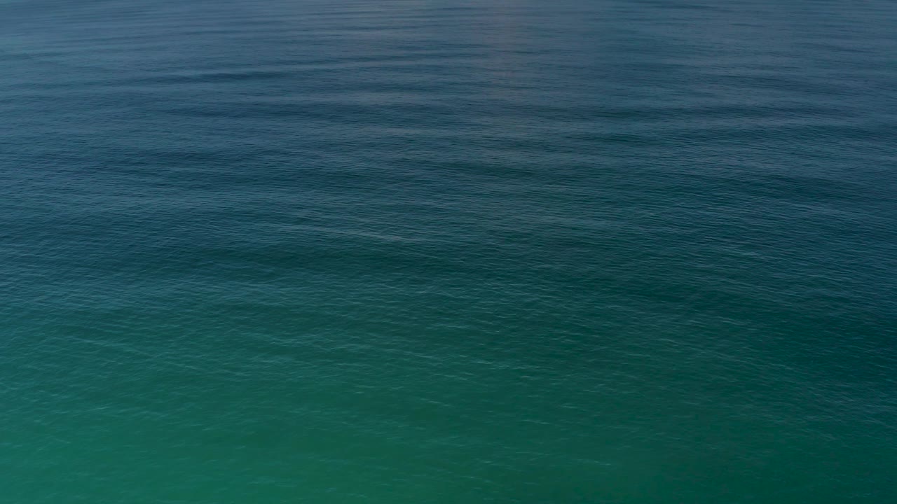 Open water in Los Cabos fills the frame with muted blue green tones, light wind texture, and no visible people.