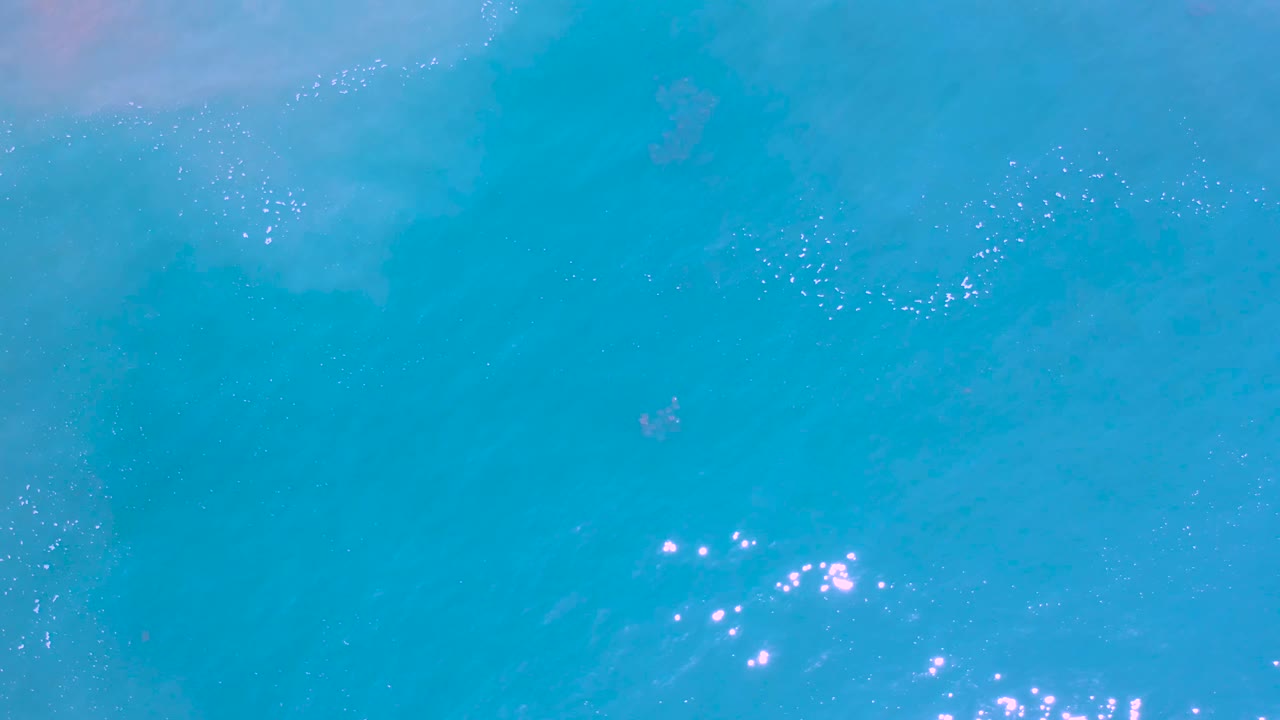 Blue ocean water with bright glints