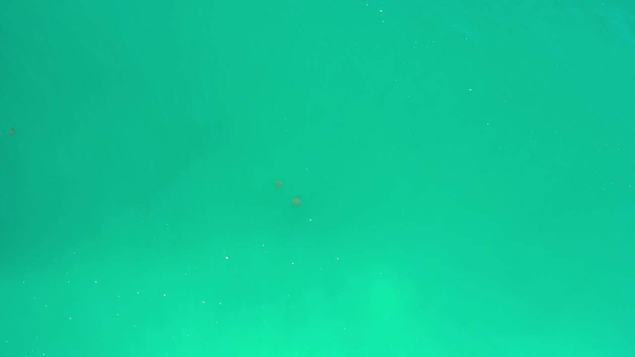 Turquoise-green water with faint wave texture