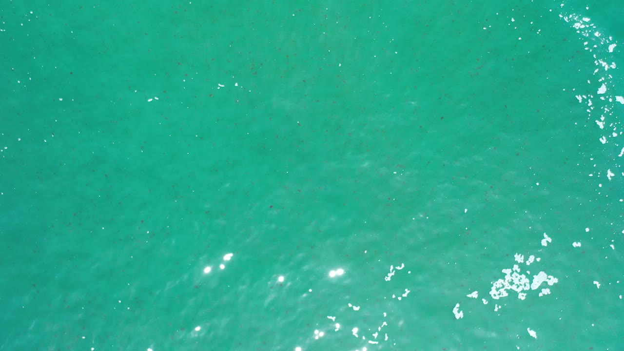 Turquoise ocean water with bright ripples