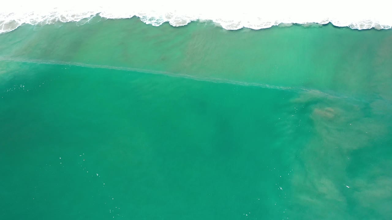 Open teal ocean water with soft underwater clouding.