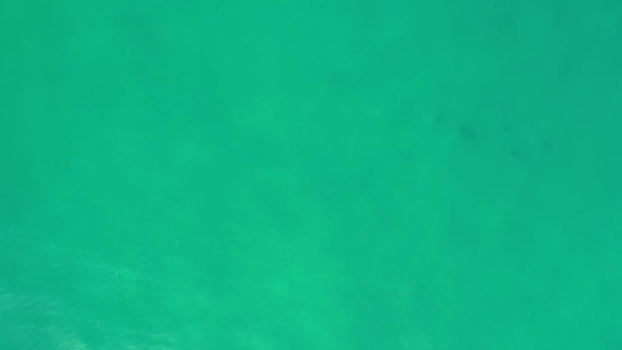 Green-blue water with small bright wave marks.