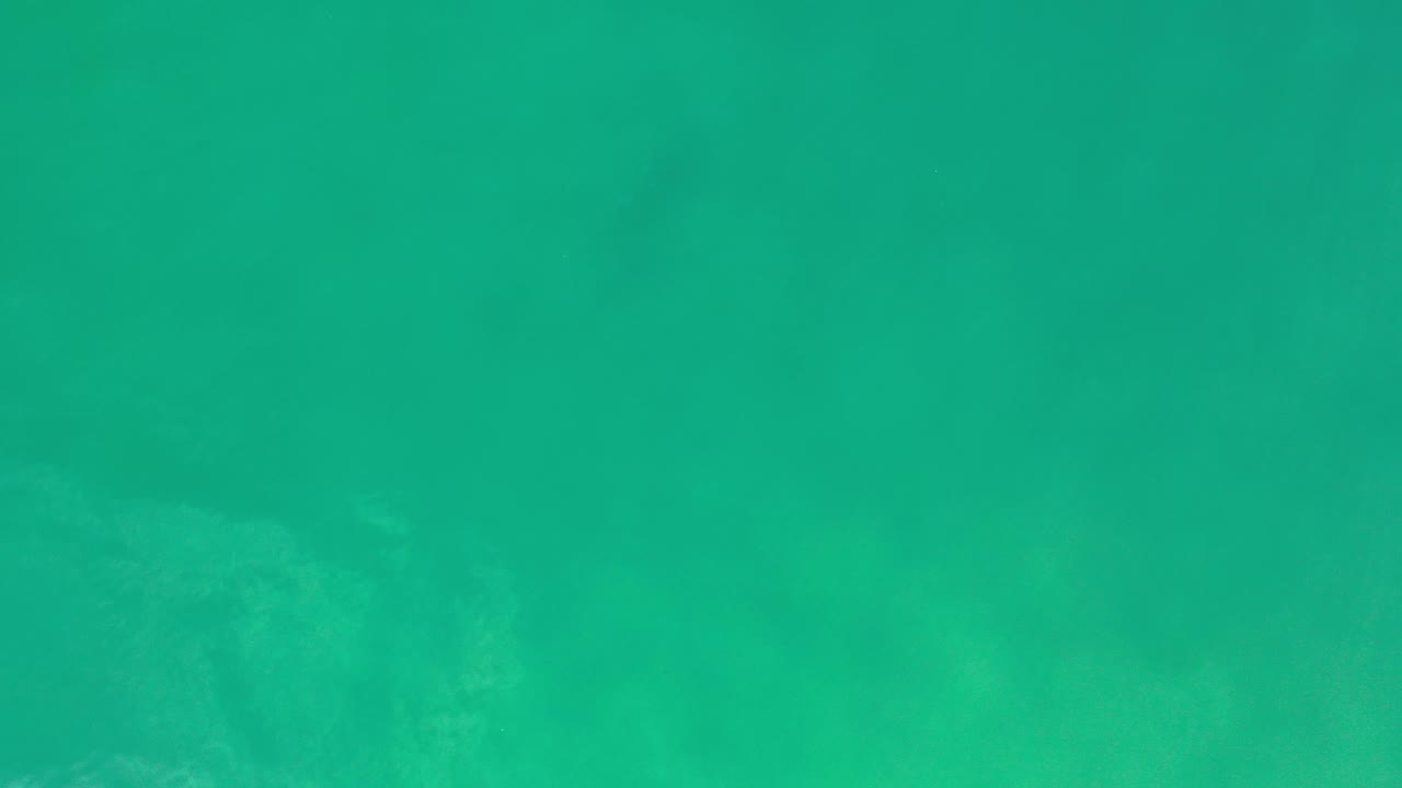 Green coastal water with darker submerged shapes