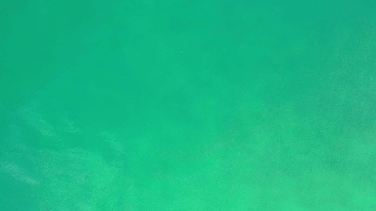 Green-tinted water fills the opening frame of the Los Cabos clip, with faint submerged texture and no visible people.