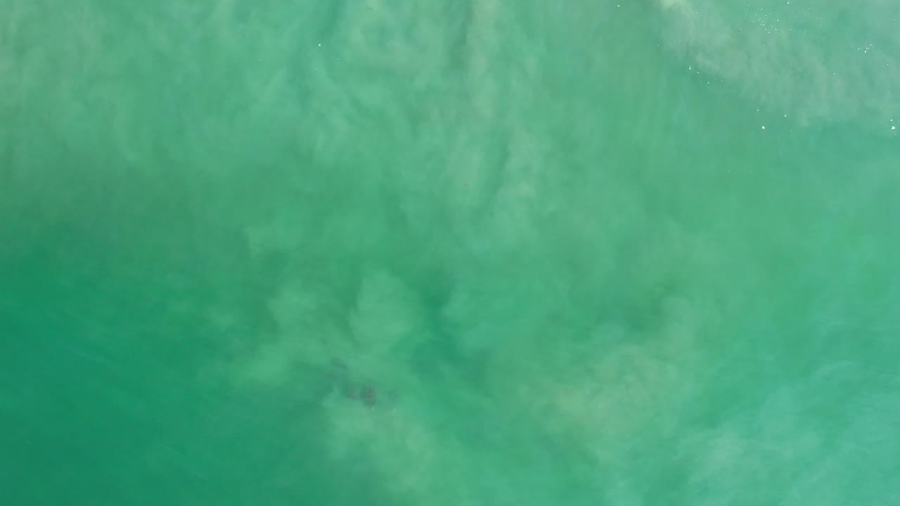 Clear green ocean texture with faint darker areas under the surface.