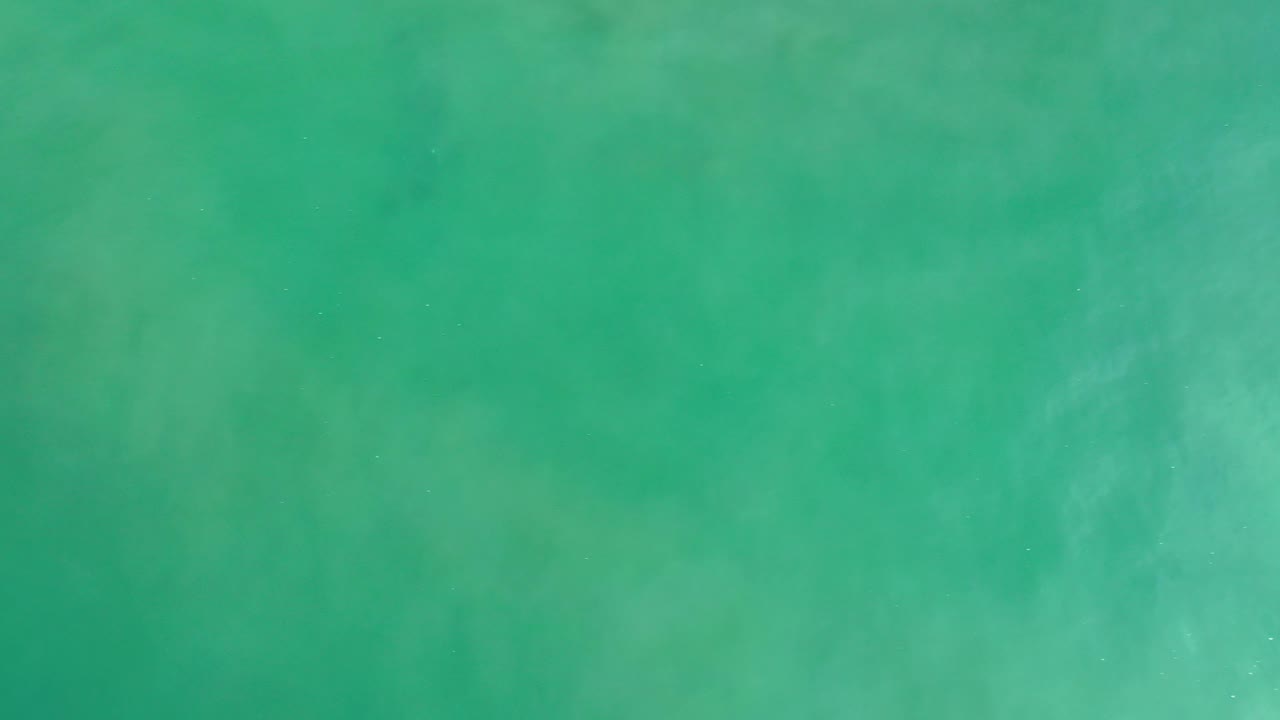 Green-blue ocean water with soft cloudy texture