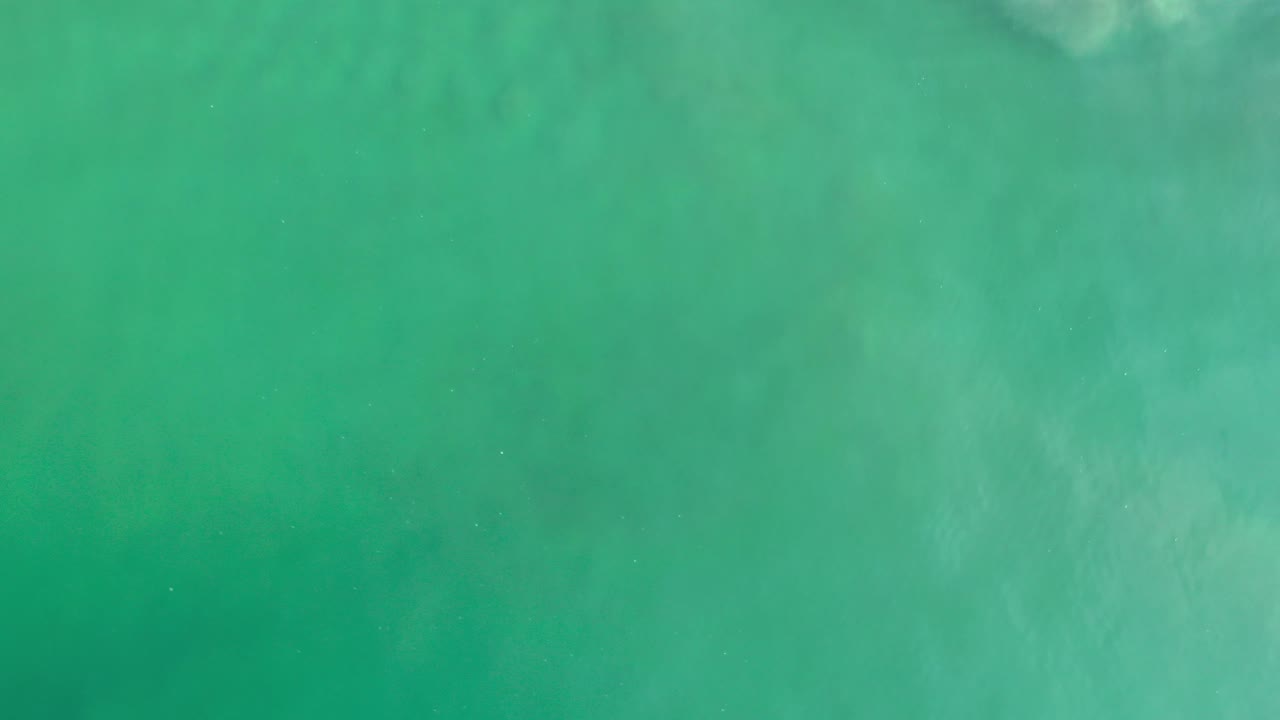 Top-down turquoise water with soft mottled patches