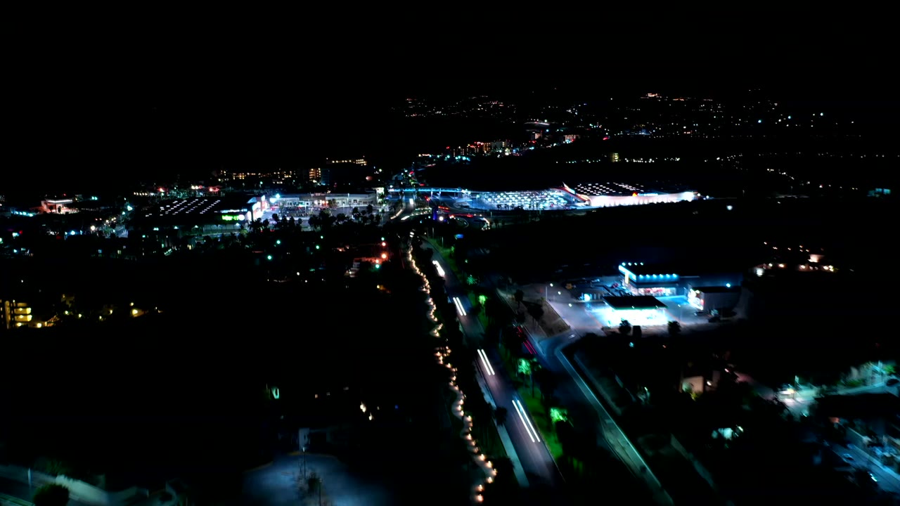 Night aerial view of lit roads and parking areas
