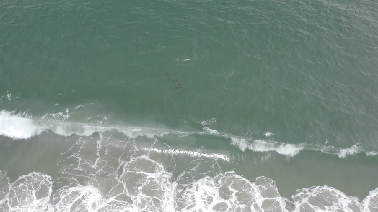 Foamy surf line over shallow ocean water