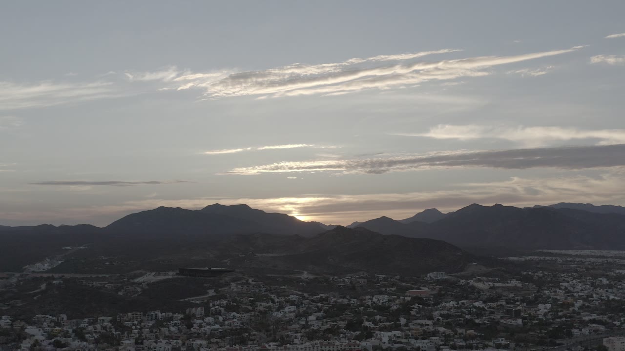 Pale evening sky and silhouetted mountains above Los Cabos