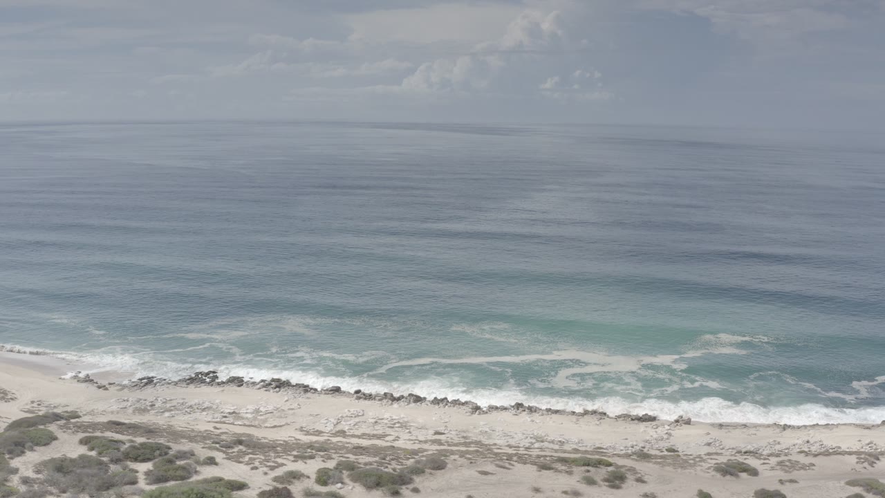 Ocean and surf line beside a rocky sandy beach