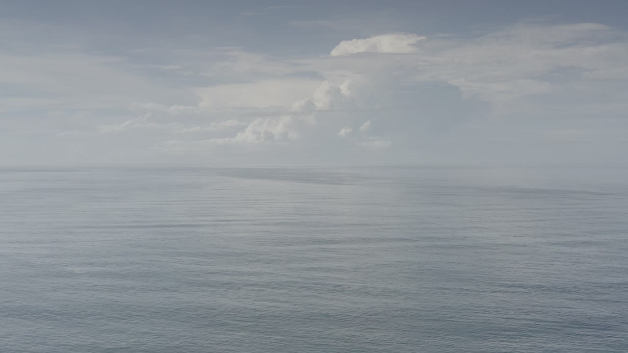 Open ocean under a cloudy blue gray sky.