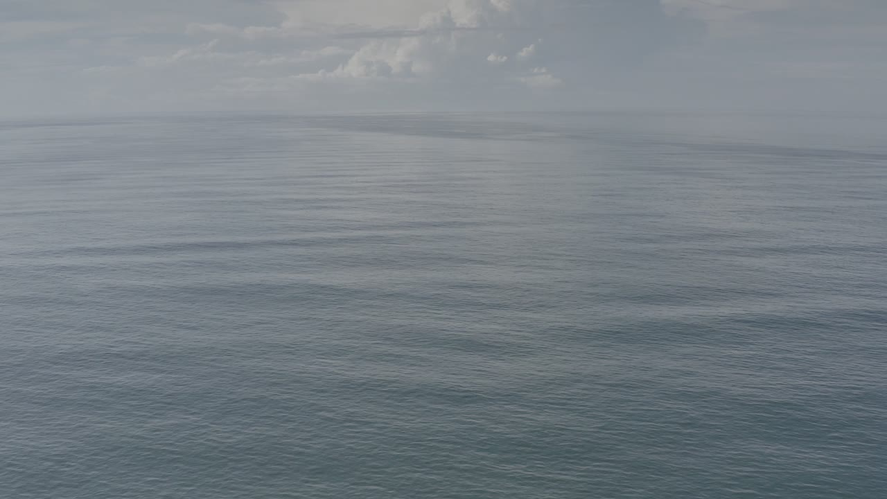 Muted aerial view across open water