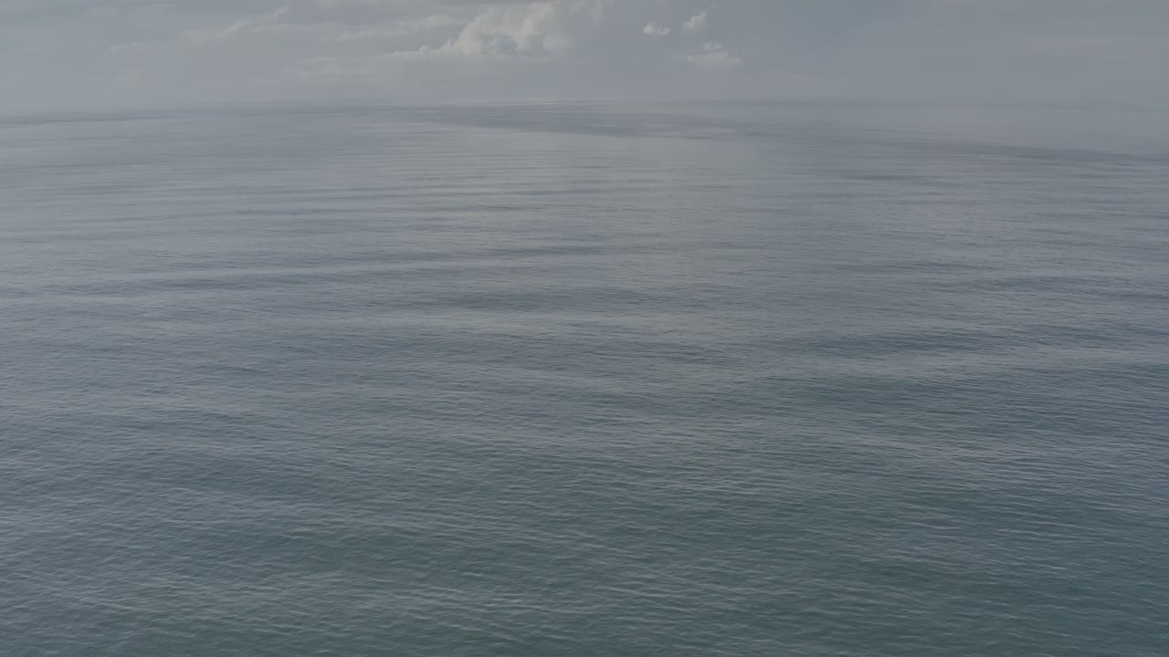 A second frame shows Los Cabos open water with slightly darker ripple bands across the foreground, thin white clouds near the horizon, and no visible people.