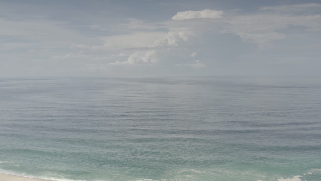 Ocean horizon with small surf at the bottom edge