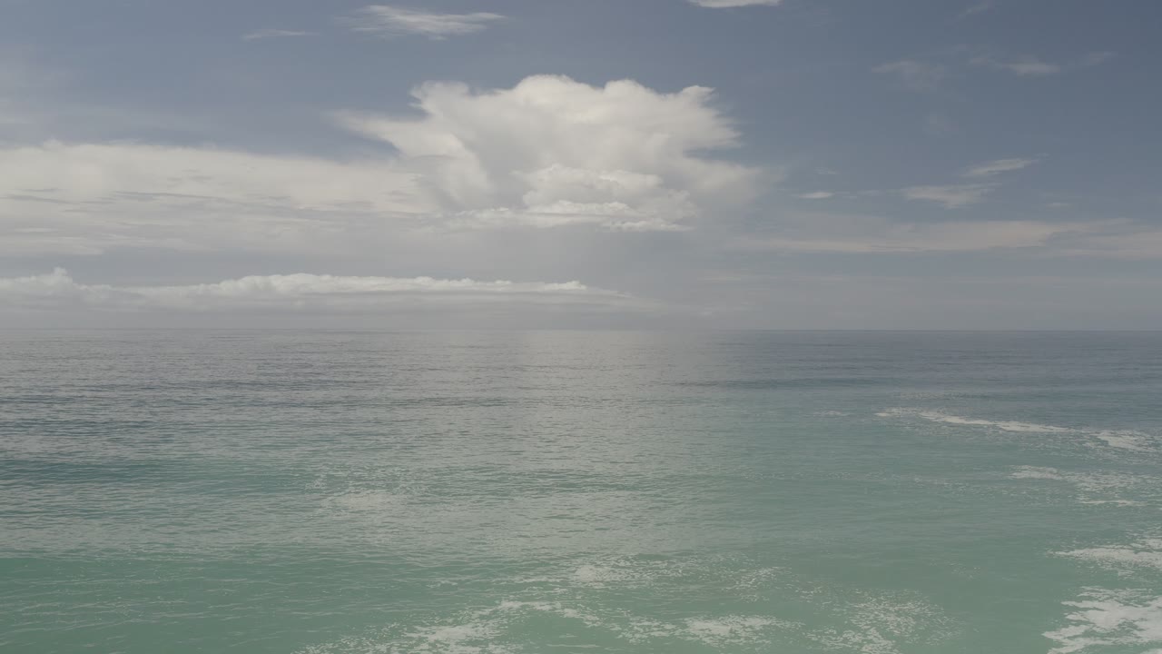 Blue-green ocean and distant cloud layer