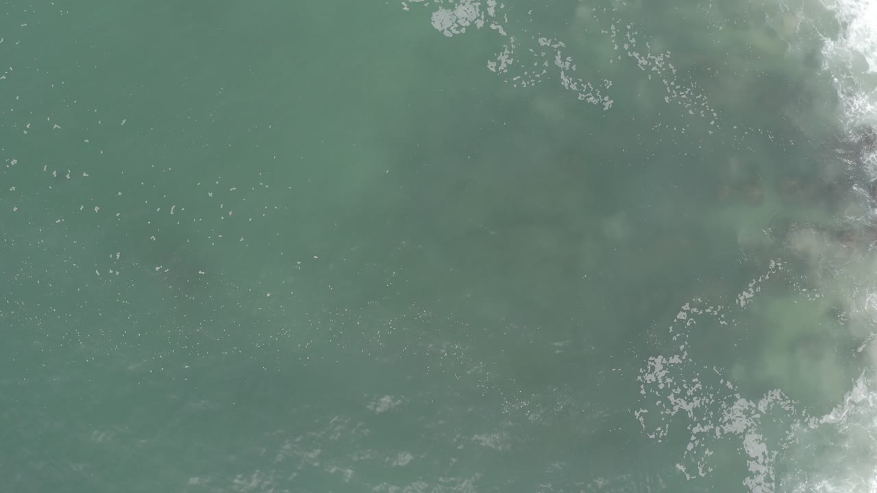Overhead green water with foam concentrated near the upper right