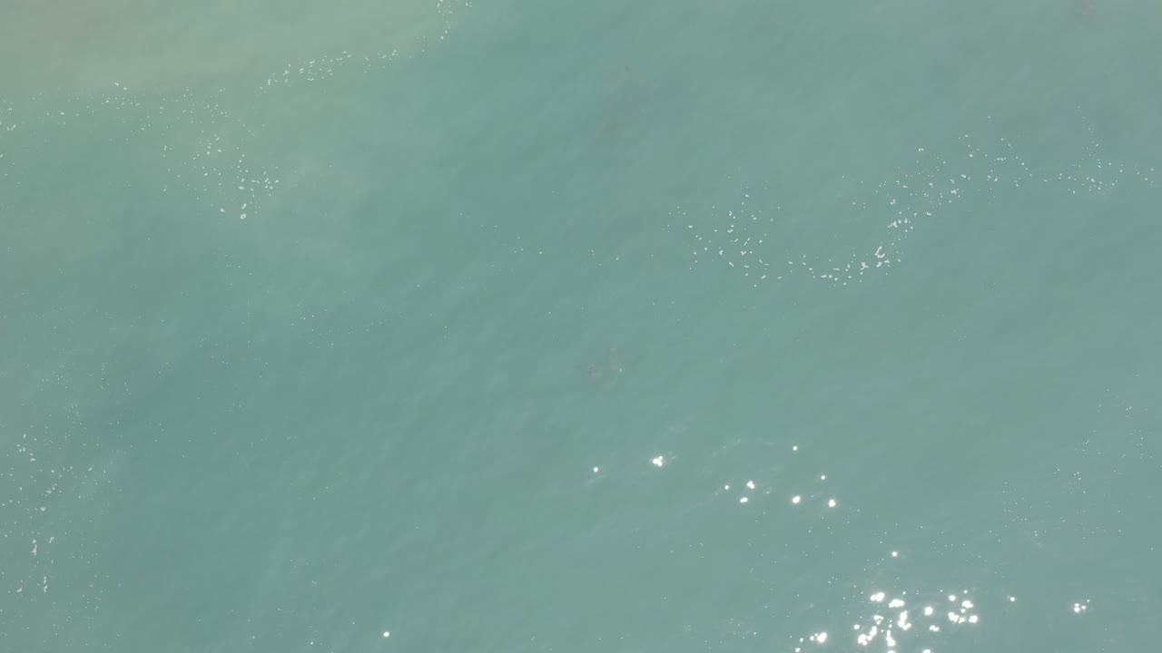 Blue ocean surface with sun sparkle at right