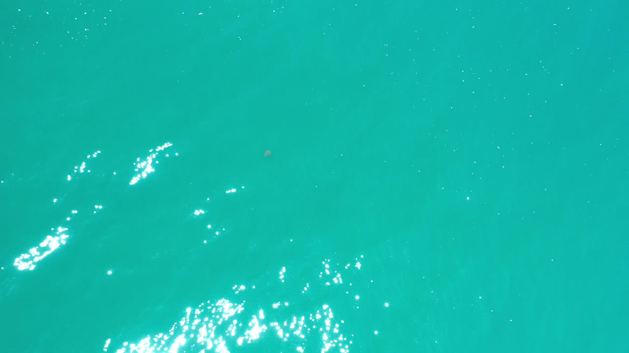 Turquoise water with stronger sun reflection on the right