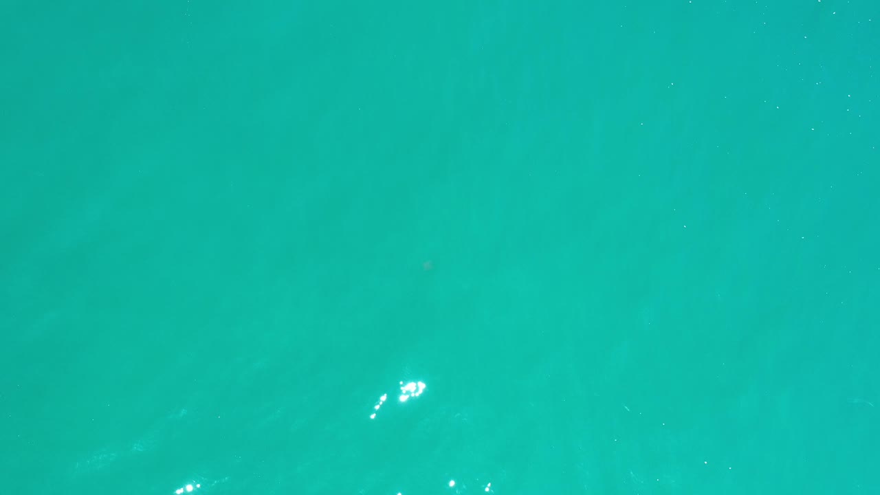 Open turquoise water with faint darker patches