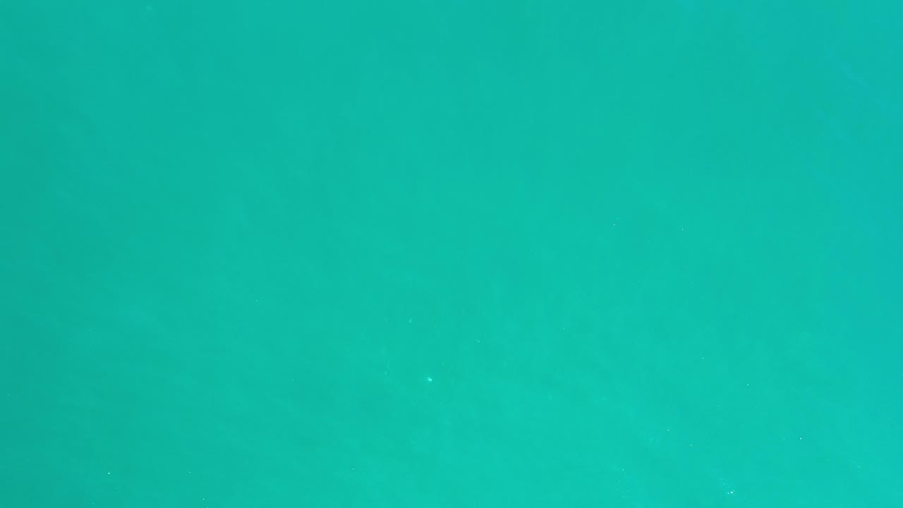 Teal sea with faint darker water patterns