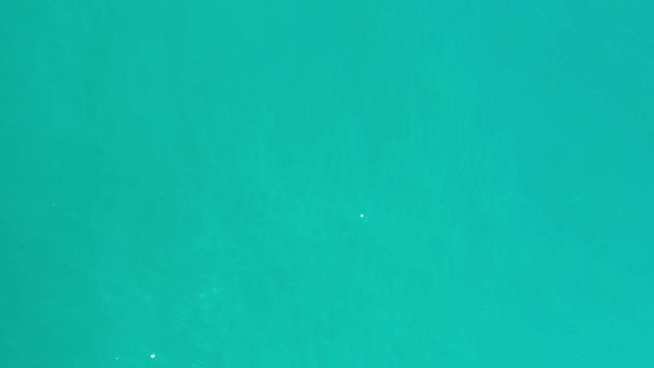Turquoise-green ocean water filling the frame.