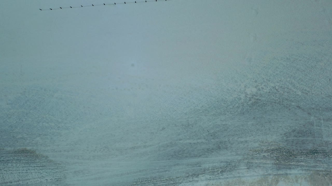 Top-down surf and sand with faint wave patterns