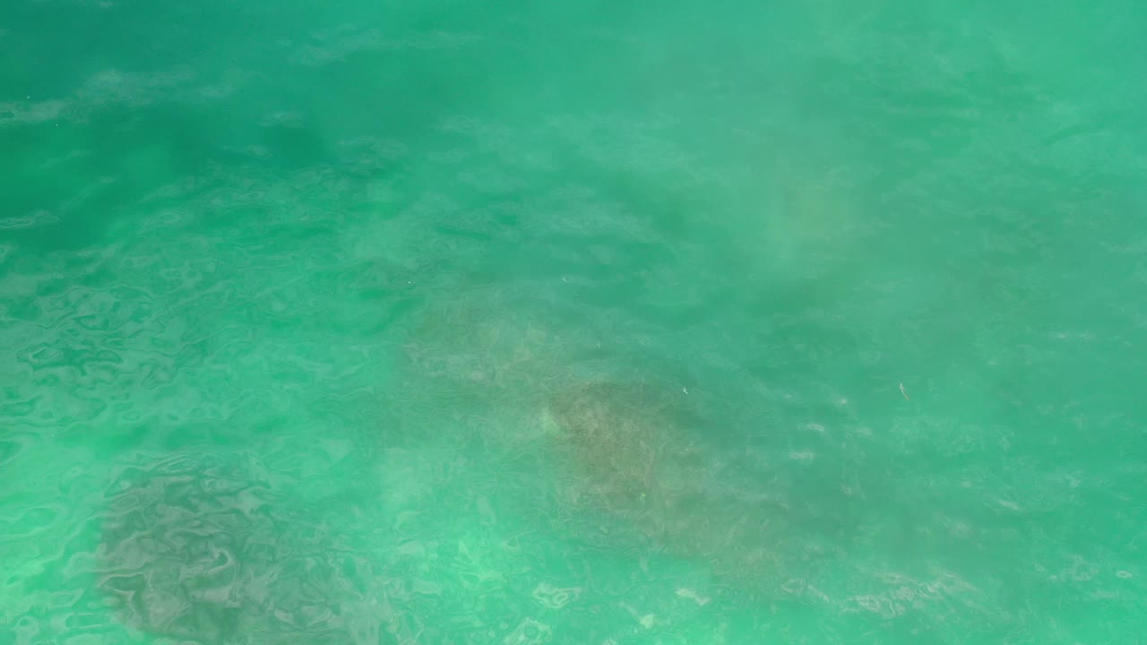 Green sea surface above darker reef areas