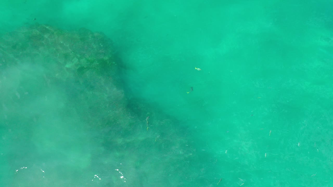 Turquoise water over a submerged rock formation
