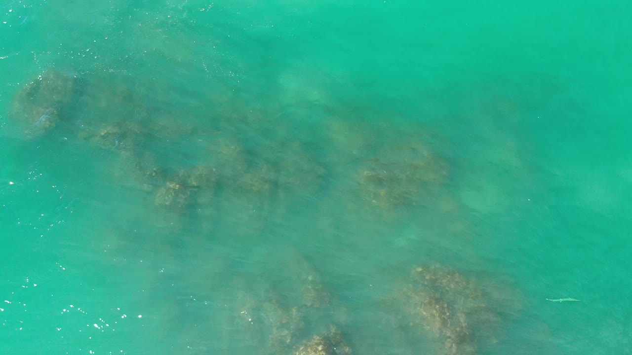 Rock clusters under turquoise coastal water