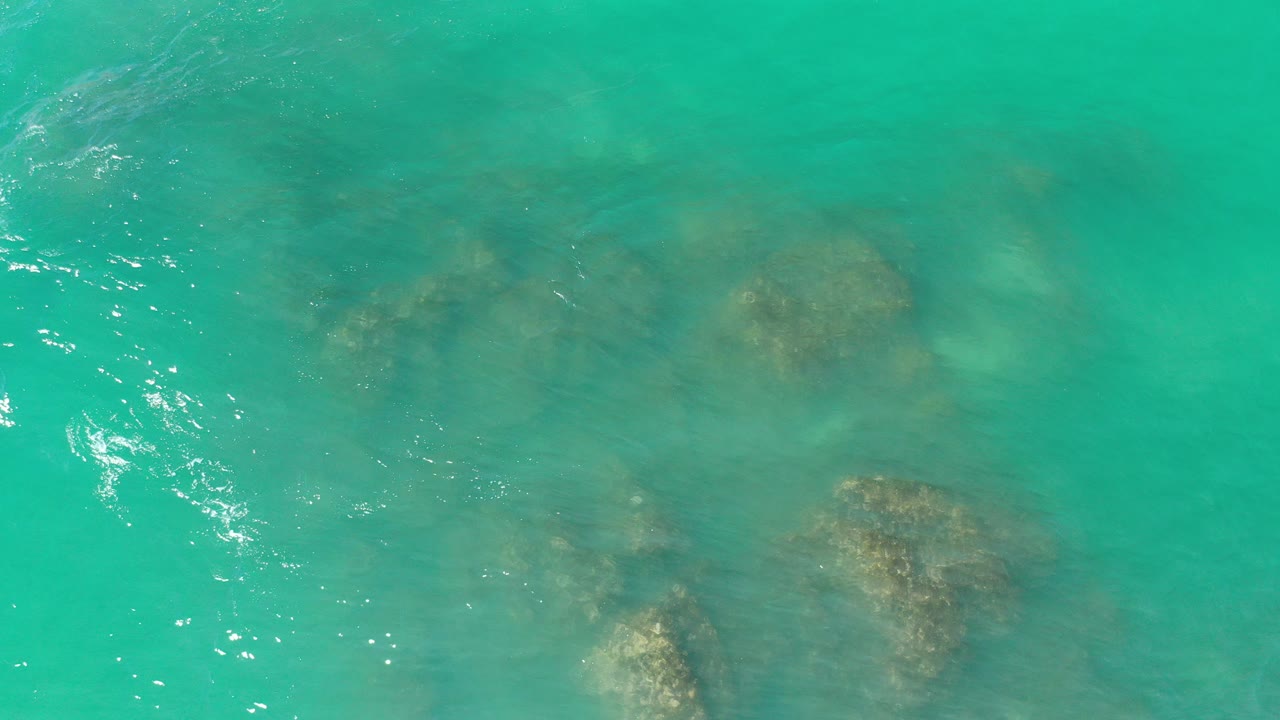 Turquoise ocean over submerged rocks