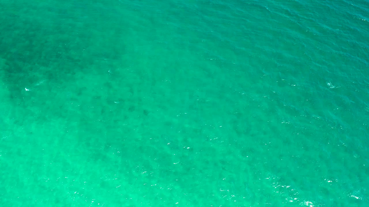 Aerial view of aqua ocean water in El Sargento La Ventana, Mexico, with a brighter shallow-looking band and no visible people.