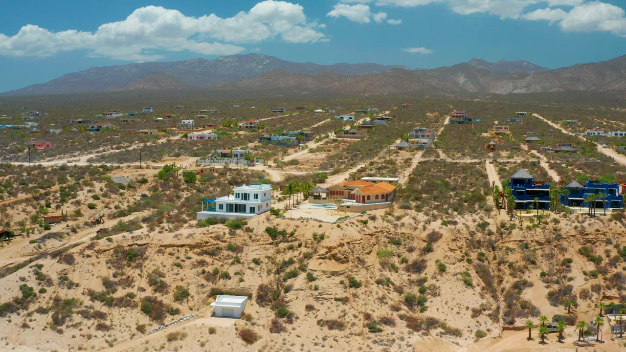 Desert neighborhood with unpaved roads and mountain horizon