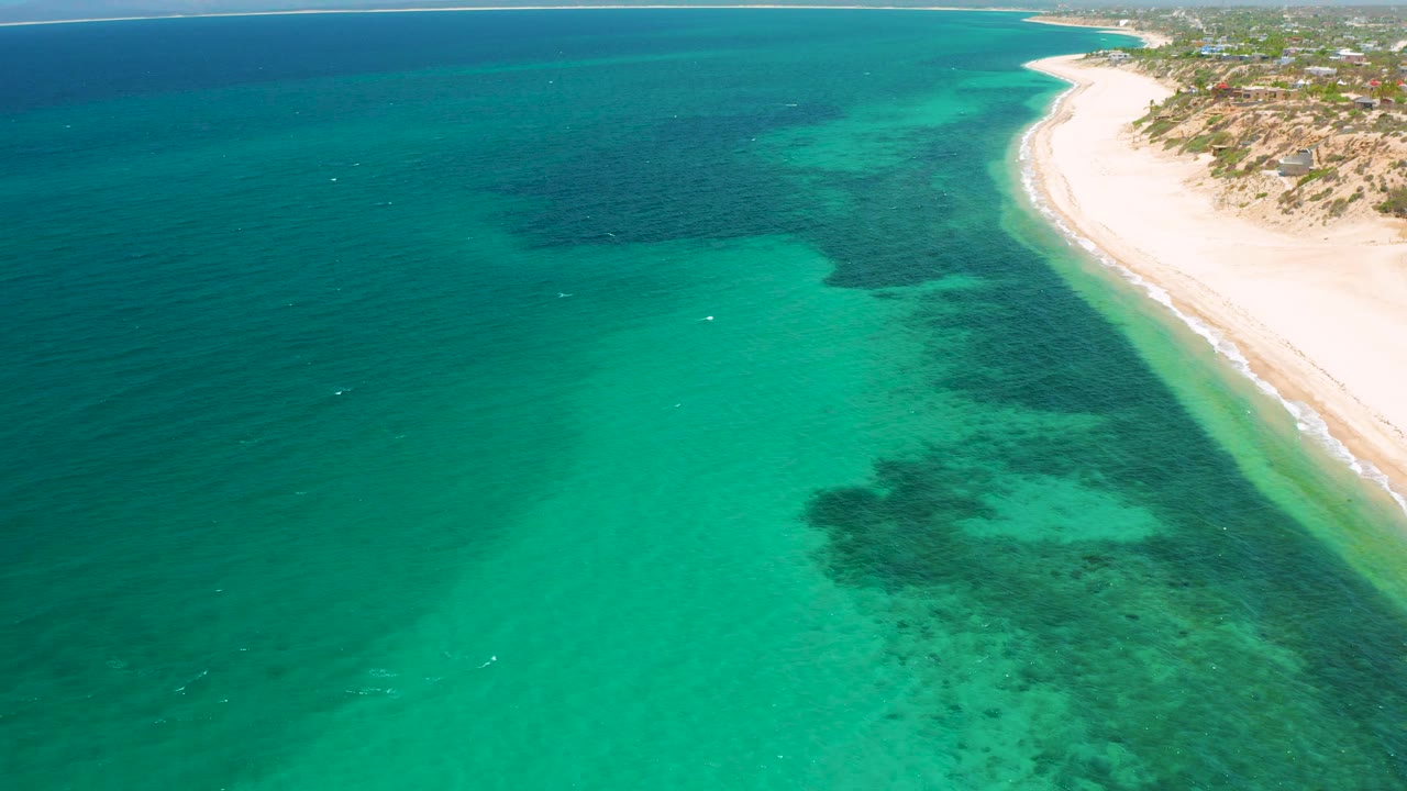 Aerial coastline with clear water and a bright sand strip