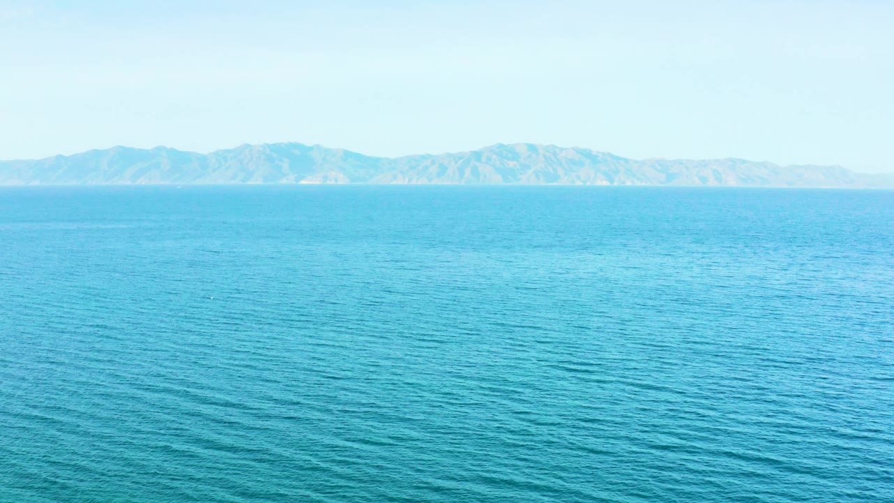 Opening frame of blue ocean off El Sargento La Ventana, Mexico, with distant mountains along the horizon and no visible people.