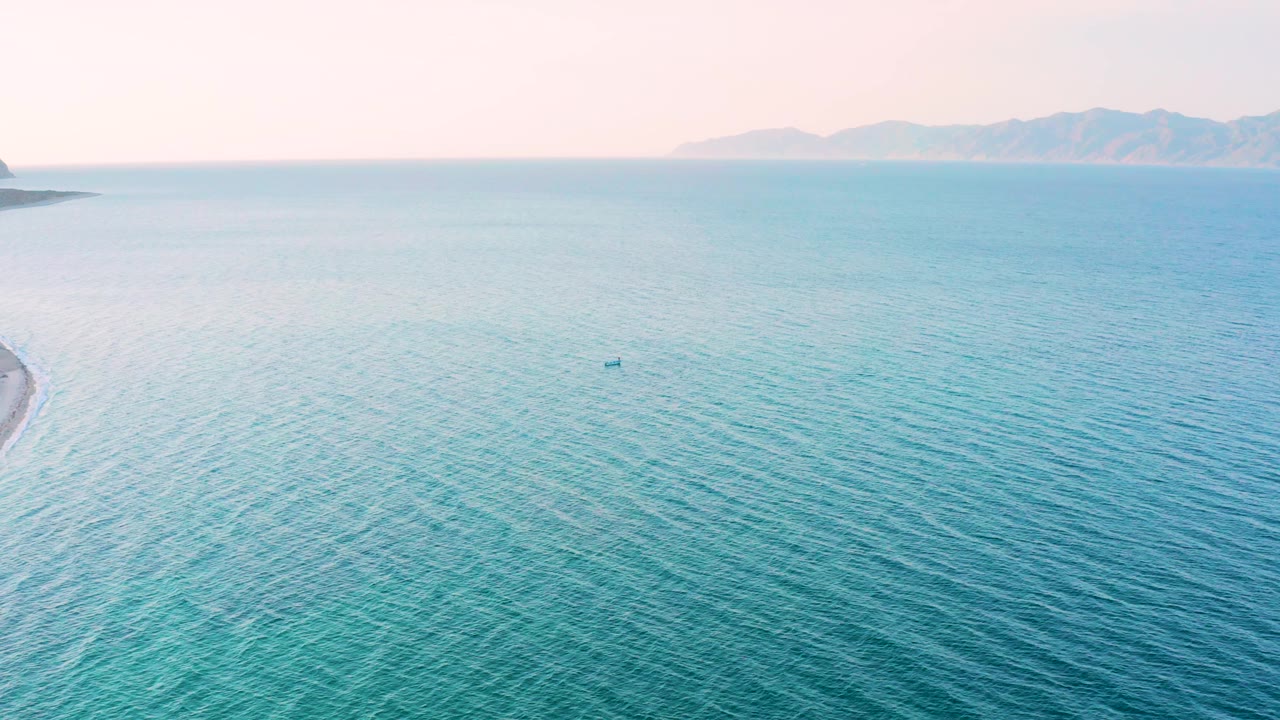 Blue ocean fills the frame near El Sargento La Ventana, Mexico, with distant landforms along the horizon and no visible people.