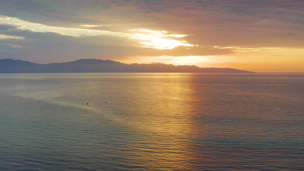 Golden sunset reflection across open water