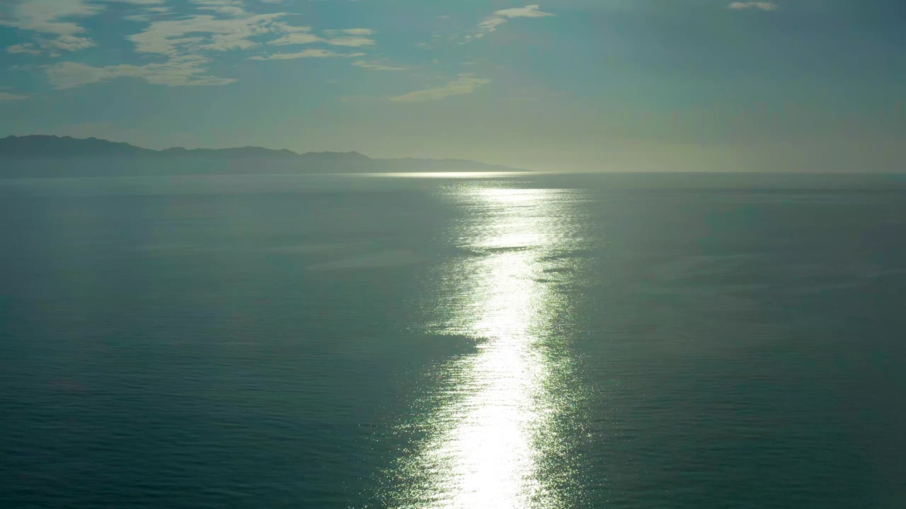 The second frame holds a wide elevated ocean view in El Sargento La Ventana, Mexico, with the bright reflection centered and no visible people.