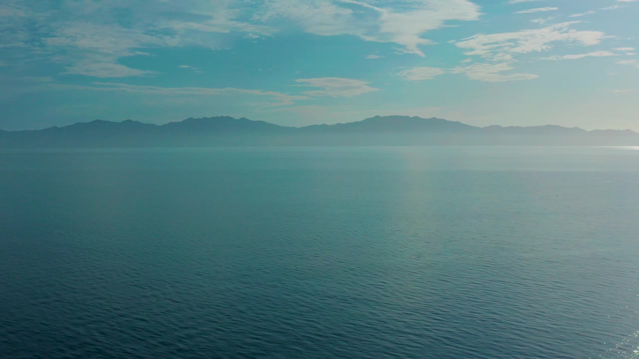 Opening frame of the El Sargento La Ventana, Mexico coastline view, with blue-green ocean below distant hazy mountains and no visible people.