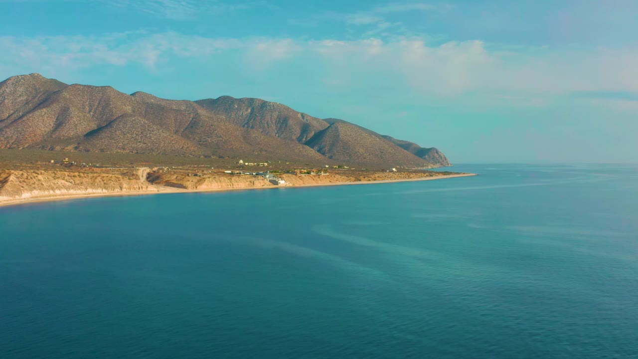 A second wide frame keeps the turquoise water dominant while the El Sargento La Ventana shoreline and dry mountain slopes remain high in frame, with no visible people.