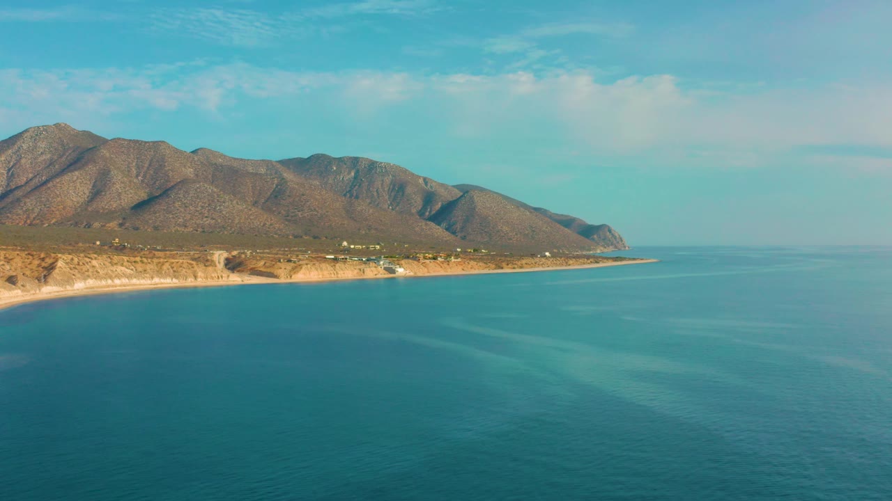 Coastal mountains above calm blue water
