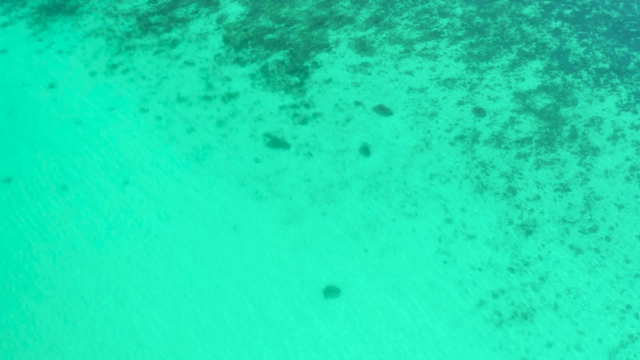 Aerial teal water with mottled underwater texture
