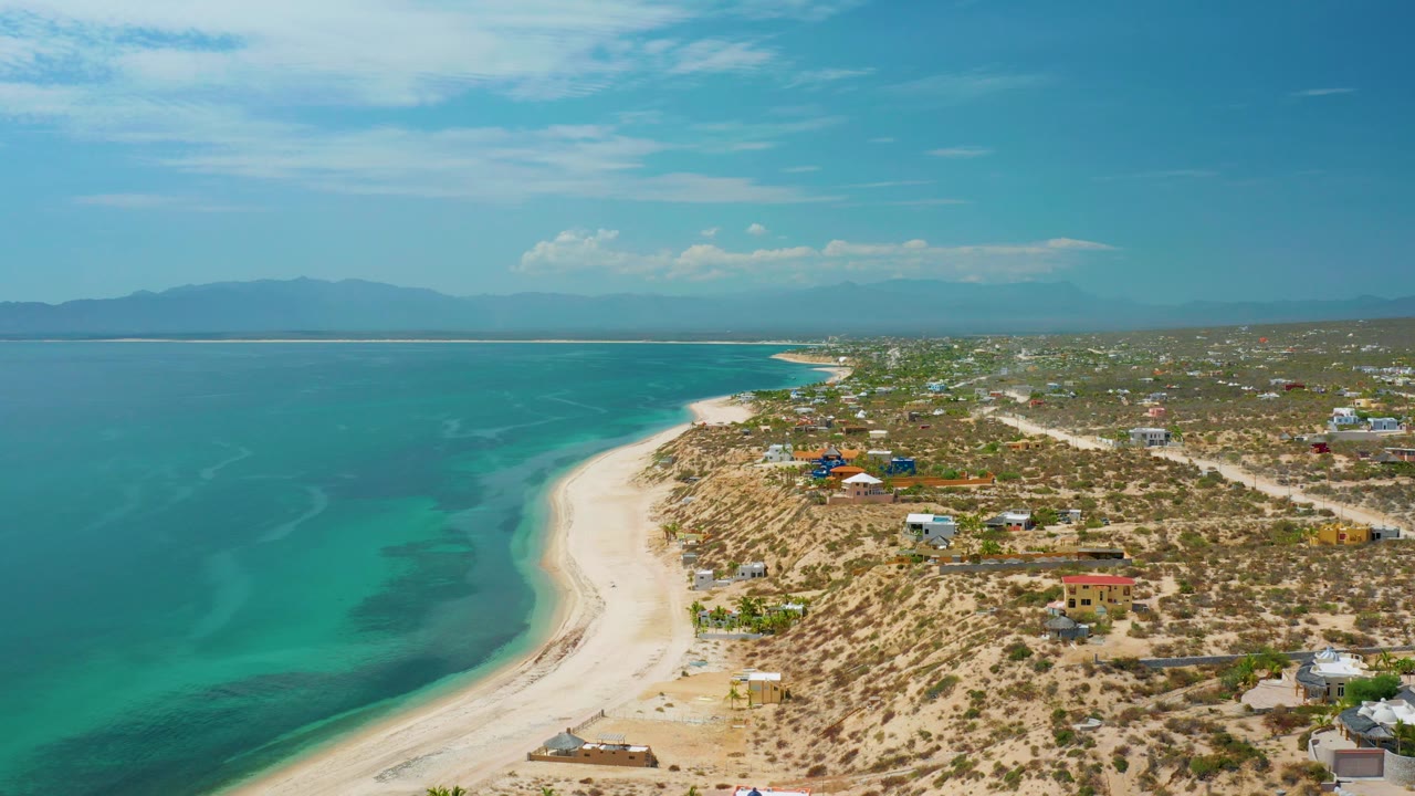 Aerial shoreline view with shallow water color and beach town edge