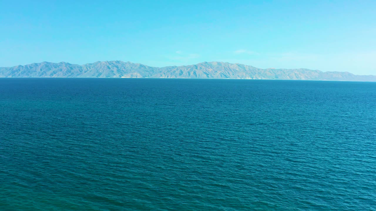 The second frame holds on open blue water with a long mountain ridge across the horizon in El Sargento La Ventana, Mexico, and no visible people.