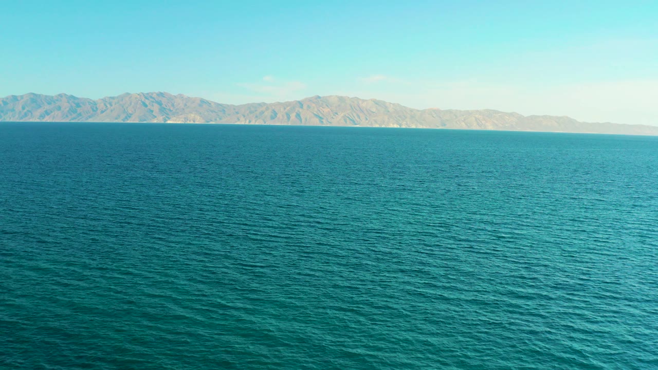 Fourth frame shows blue-green sea in the foreground of El Sargento La Ventana, Mexico, with a long mountain backdrop and no visible people.