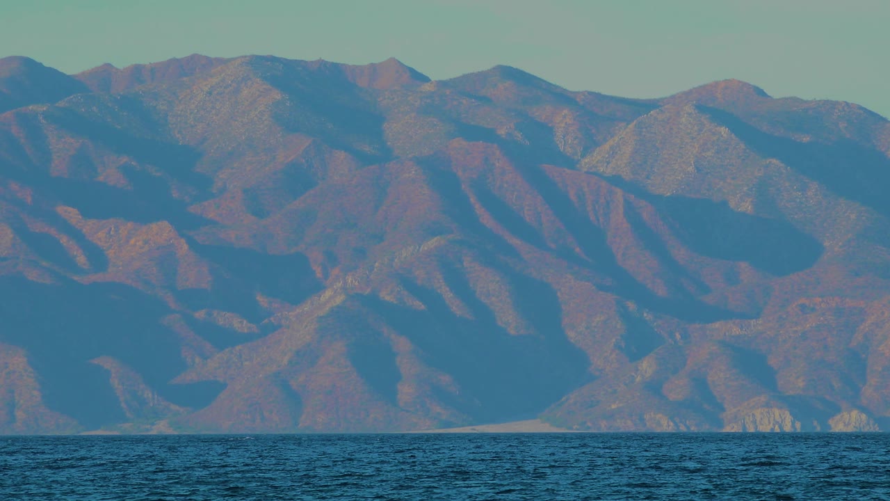 Third frame shows a wide coastal mountain view over blue ocean water in El Sargento La Ventana, Mexico, with warm highlights on the ridges and no visible people.