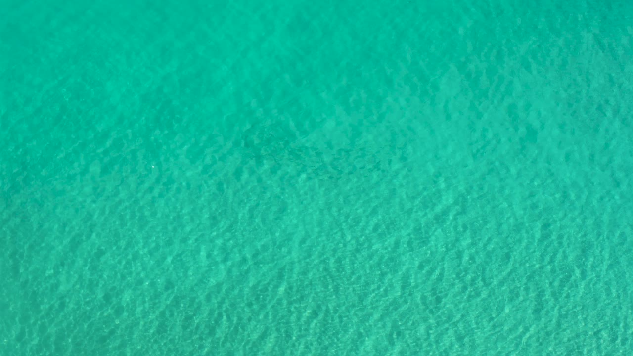 Even turquoise water texture across the frame