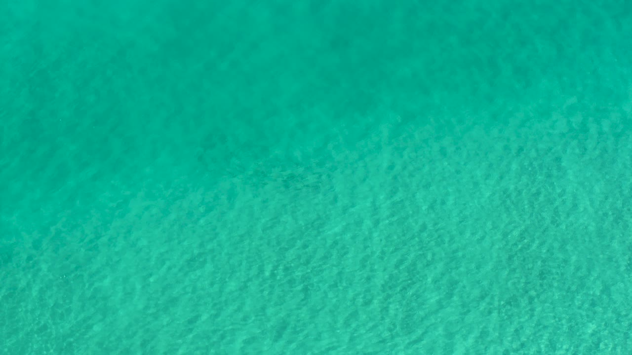 Blue-green ocean water in Los Cabos fills the frame with fine wind ripples and no visible people.