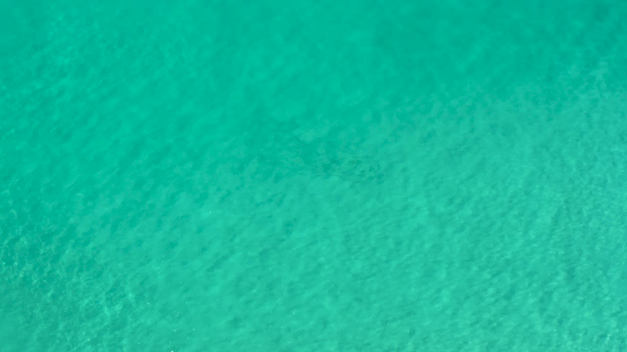 Turquoise ocean water filling the frame.